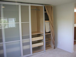 Modular closet unit installed in bedroom